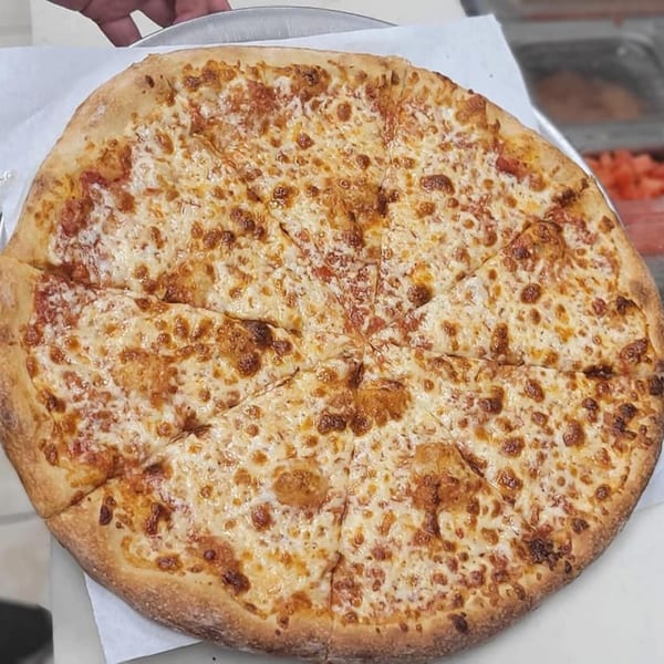 A freshly baked, sliced cheese pizza from Habibi's Cafe & Pizzeria, with golden-brown crust and melted cheese.